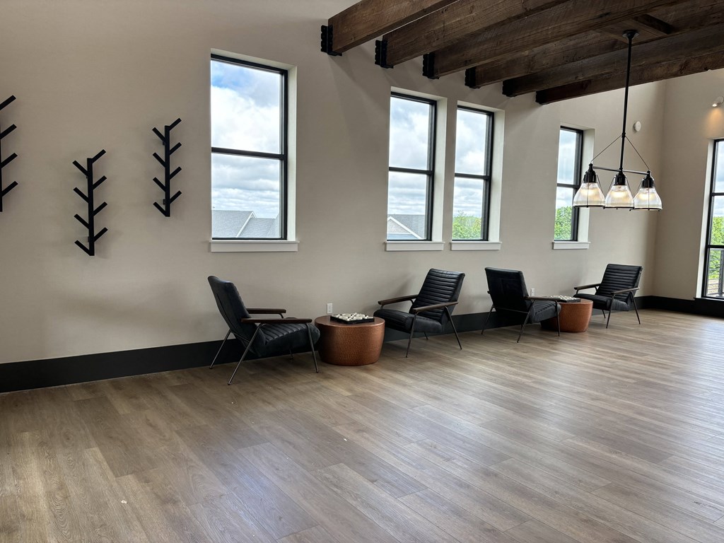 a living room with chairs and a wood floor