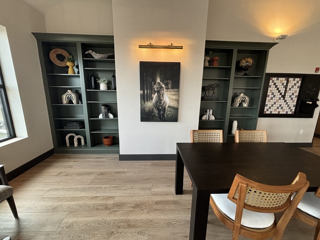 a dining room with a table and chairs and a bookshelf
