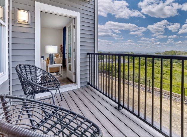 a balcony with two chairs and a table