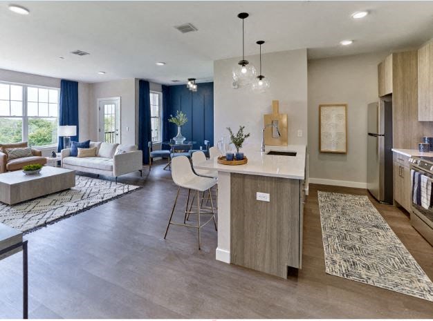 a kitchen and living room with a couch and a table