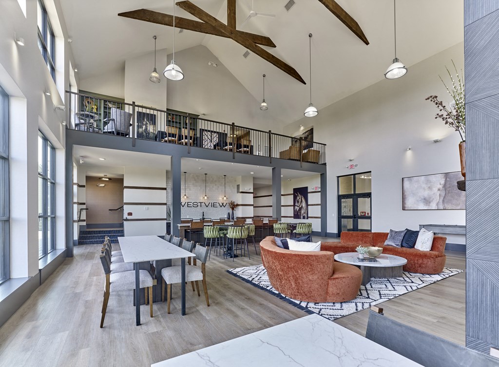 a living room with couches and chairs and a table