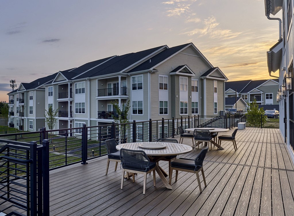 an apartment building with a patio with a table and chairs on it