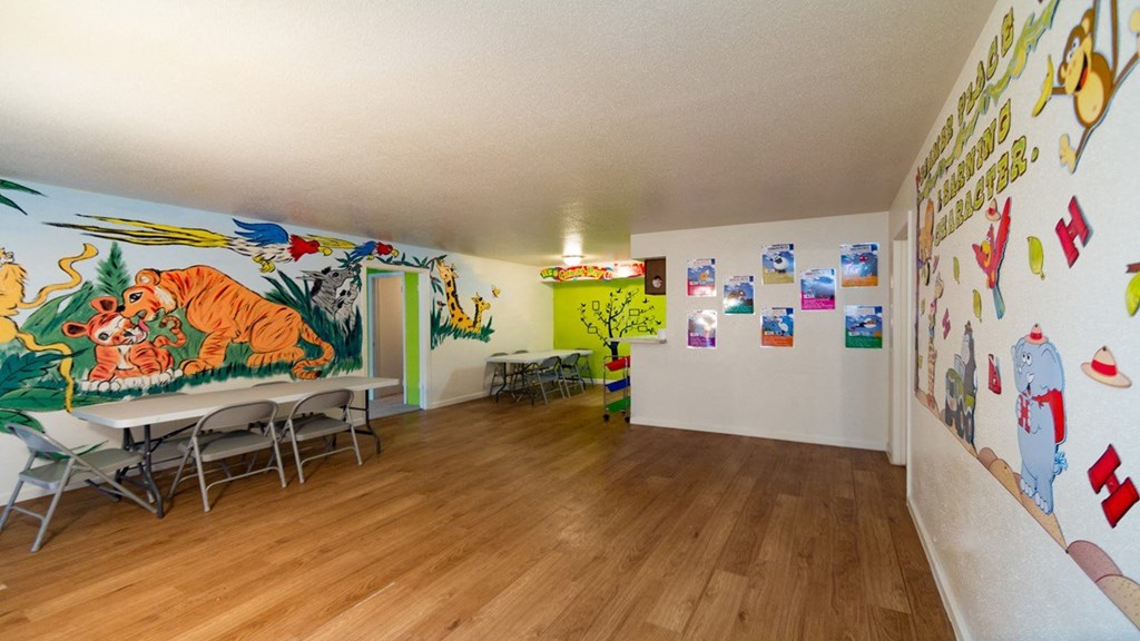 a dining room with a large mural on the wall and tables and chairs