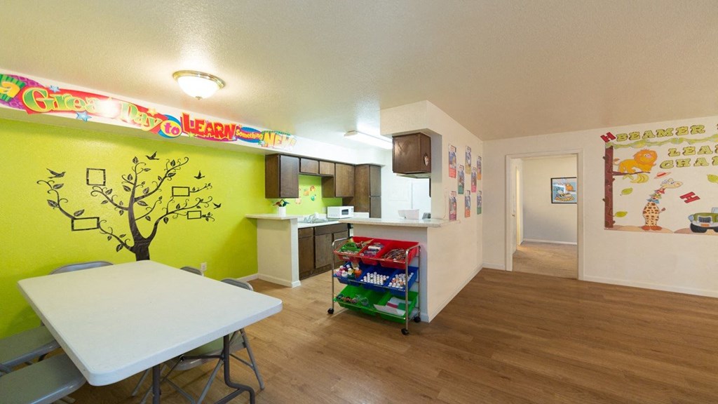 a dining room and kitchen with a table and a refrigerator