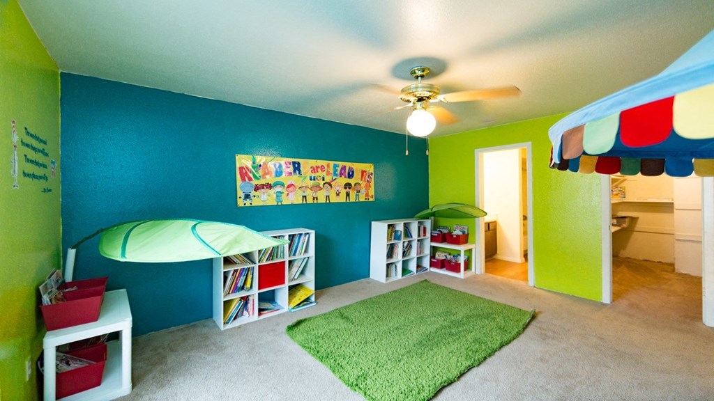a childrens room with a bed and a ceiling fan