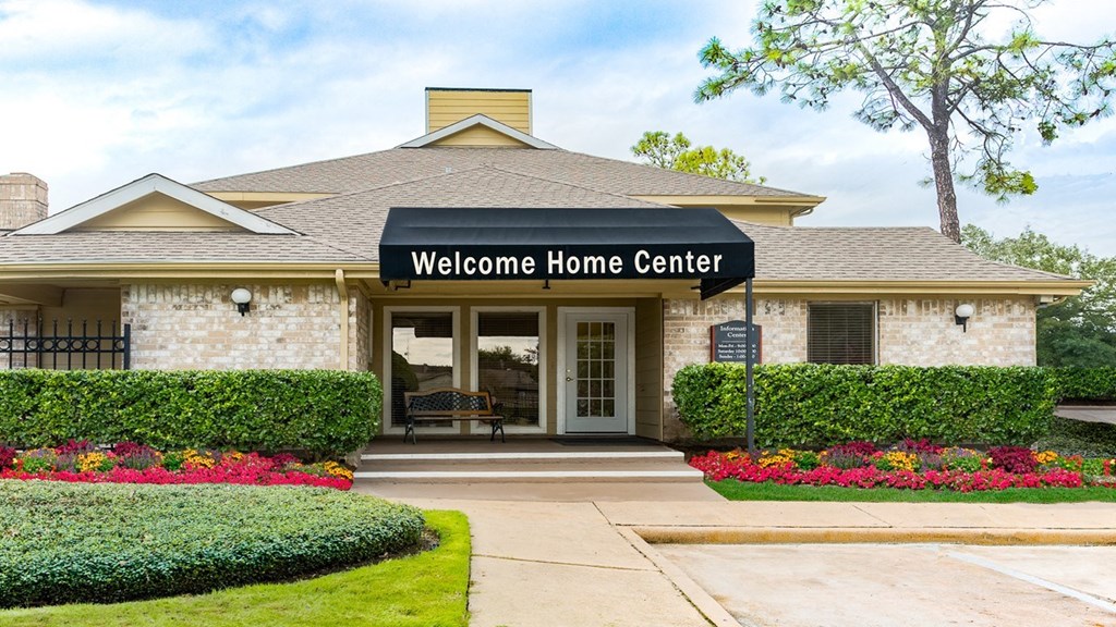 the entrance to the welcome home center in a brick building
