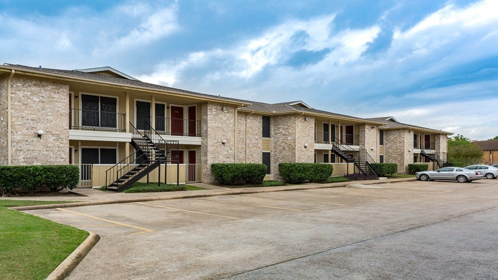 a parking lot in front of an apartment building
