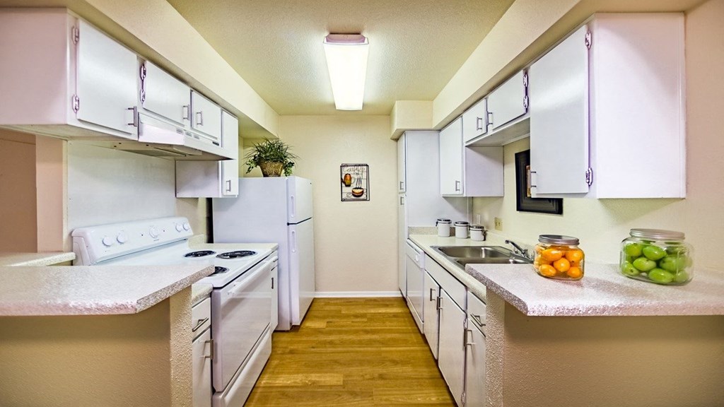 a kitchen with white appliances and white cabinets