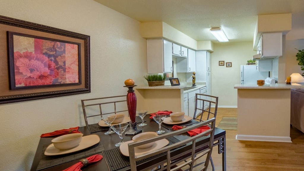a dining room with a table and chairs and a kitchen