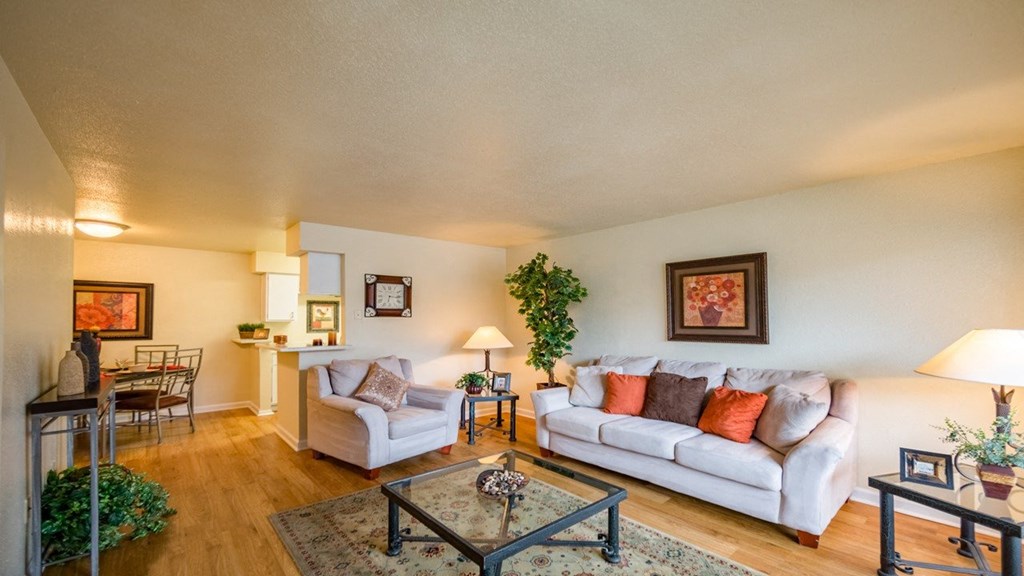 the living room of a house with a couch and chairs