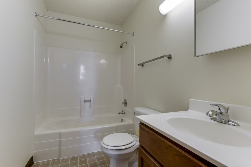 an empty bathroom with a sink toilet and shower