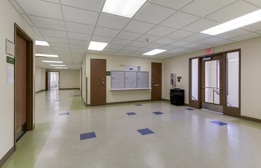 an empty room in a hall with blue tiles on the floor
