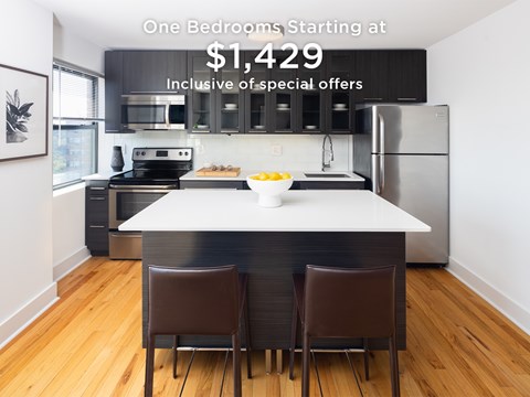 A kitchen with a table and two chairs is advertised for rent.