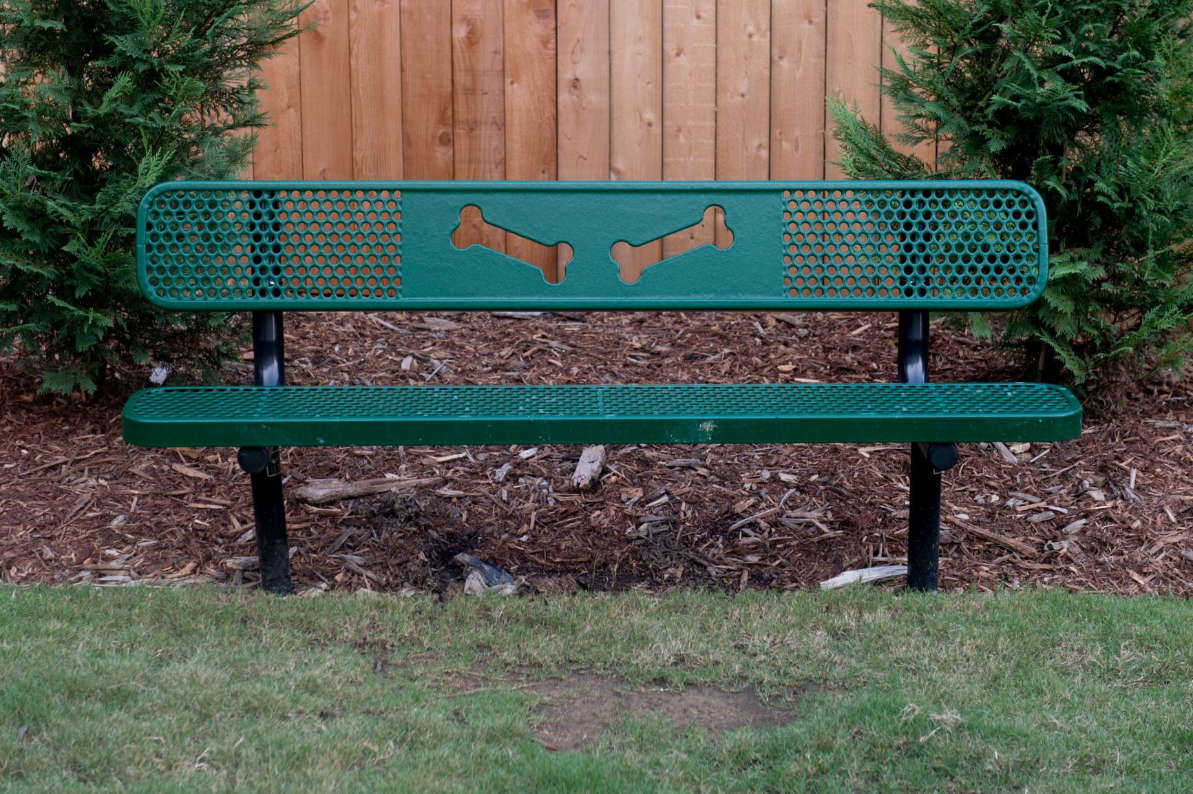 a bench with dogs on it in a yard
