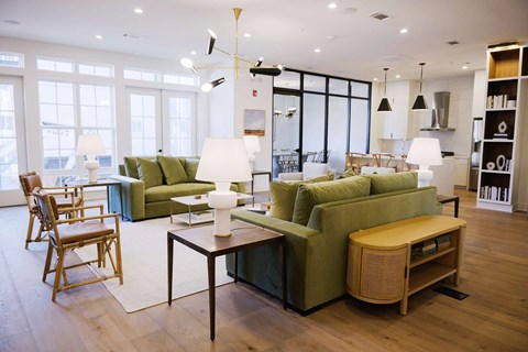 A living room with a green couch and a wooden table.
