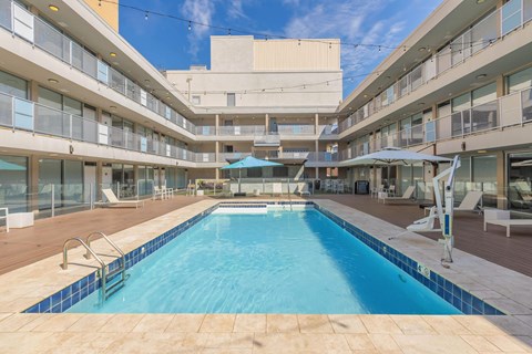A large indoor pool in a multi-story residential building.