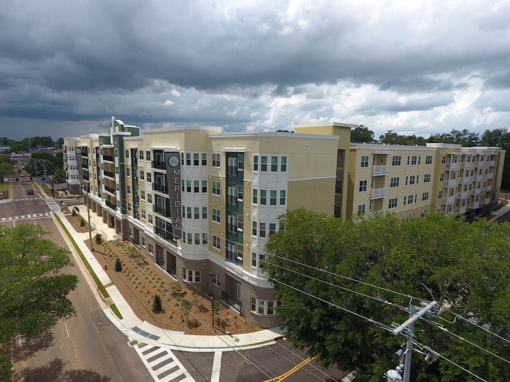 an aerial view of an apartment complex with a cloudy sky
