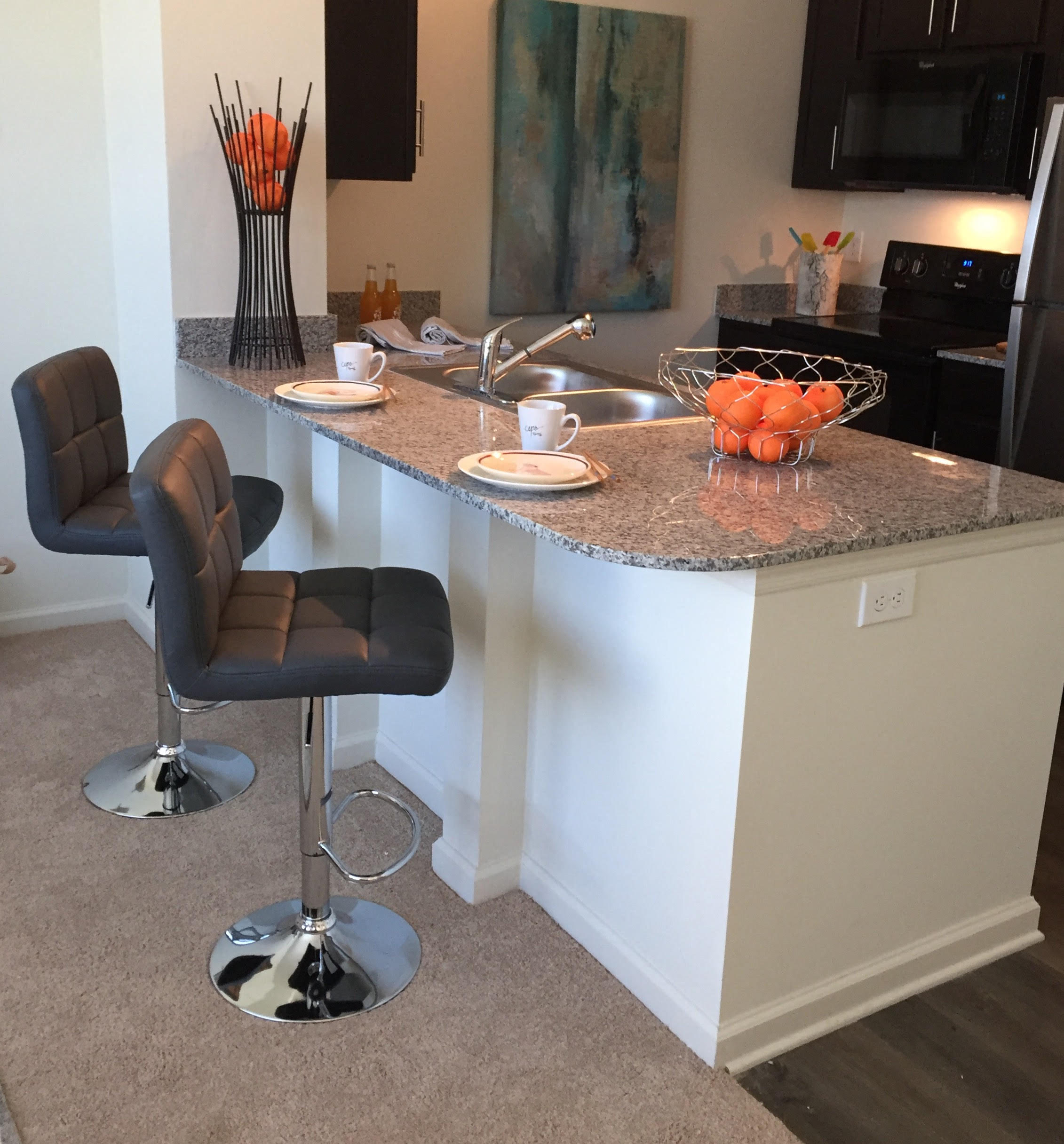 a kitchen with a counter top and bar stools