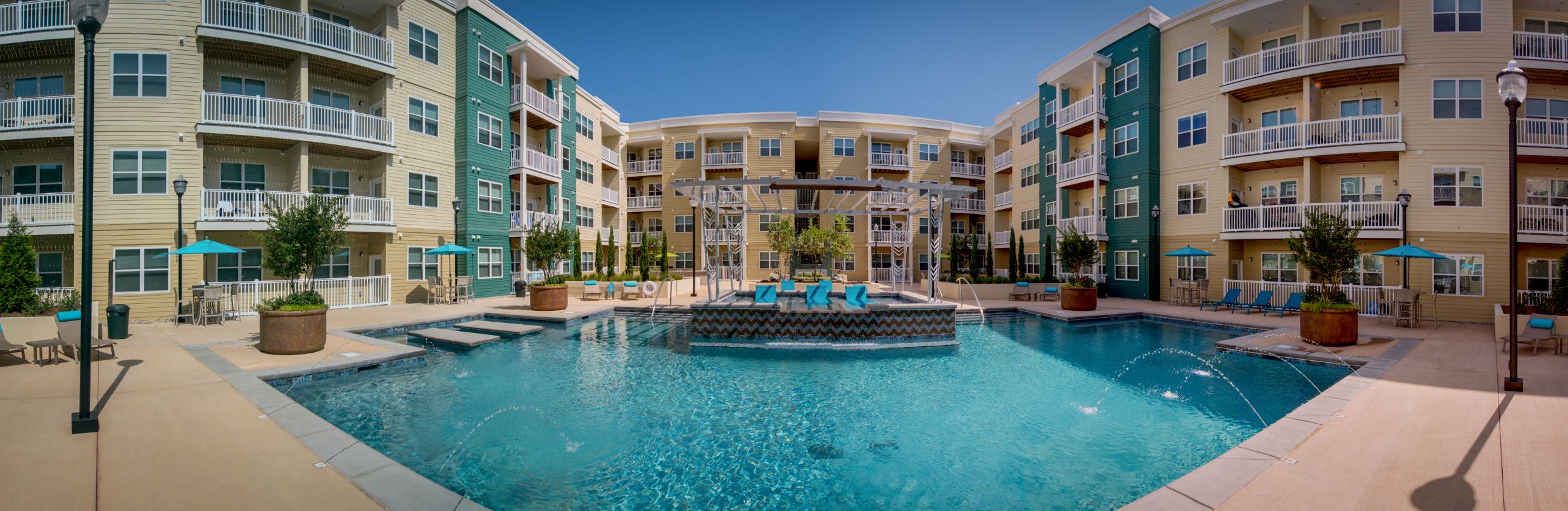 an apartment building with a large pool in front of it