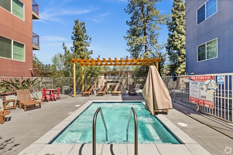 A pool area with a slide and sun loungers.