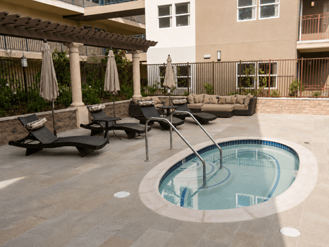 A small round pool with a ladder in the middle of it.