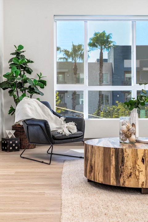 a living room with a chair and a coffee table