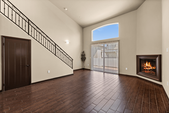 an empty living room with a fireplace and a staircase at Le Blanc Apartment Homes, Canoga Park, 91304