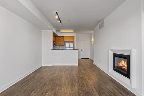 a living room with a fireplace and a kitchen