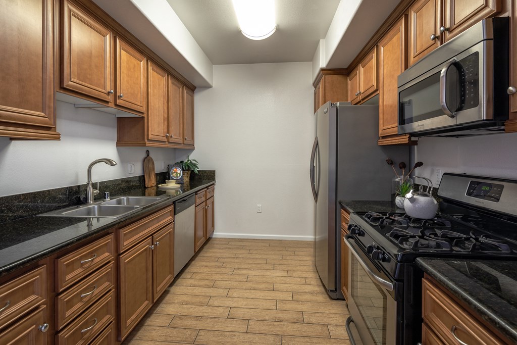 a kitchen with stainless steel appliances and wooden cabinets