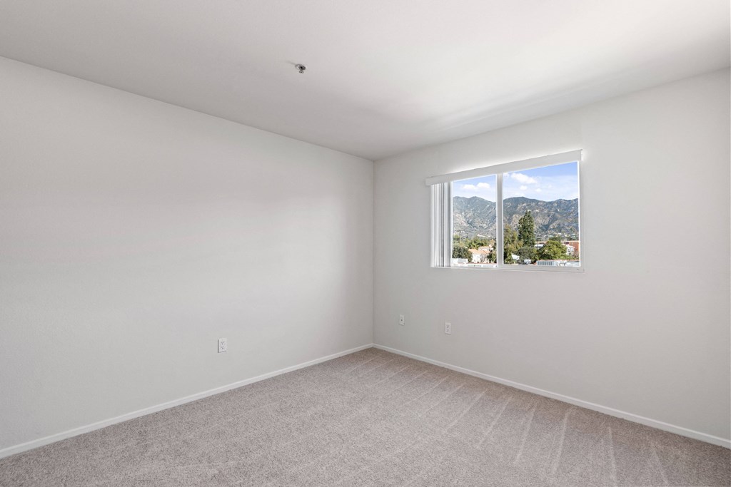 a room with white walls and a window