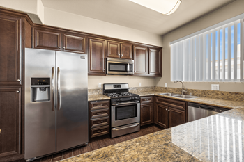 a kitchen with stainless steel appliances and granite counter tops