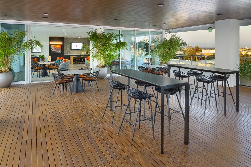 a cafeteria with tables and chairs on a wooden floor