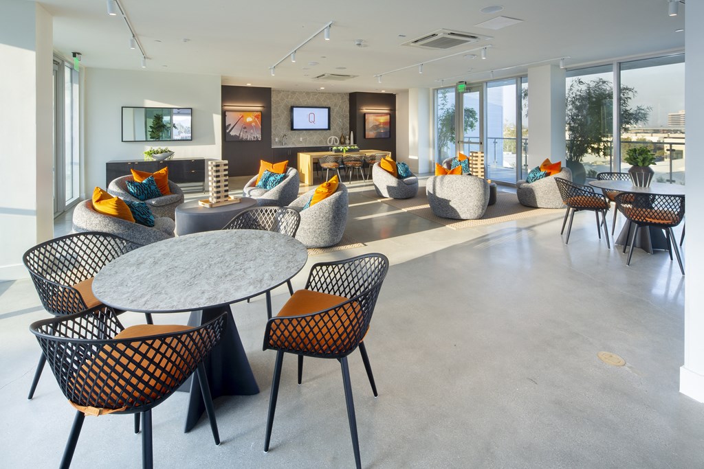 the lobby of an office building with tables and chairs