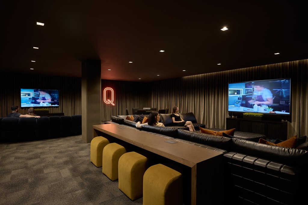 A room with a bar and a television on the wall.