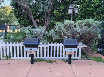 two parking meters in front of a white fence at Le Blanc Apartment Homes, California, 91304
