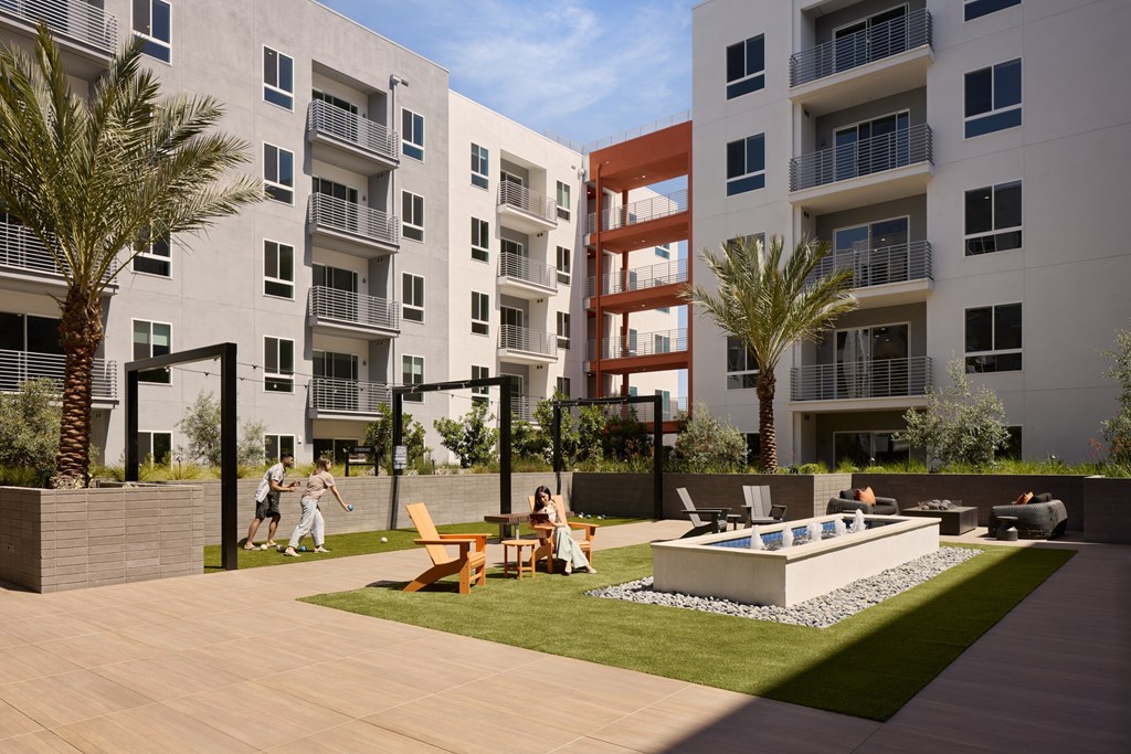 A modern apartment complex with a pool and a playground.