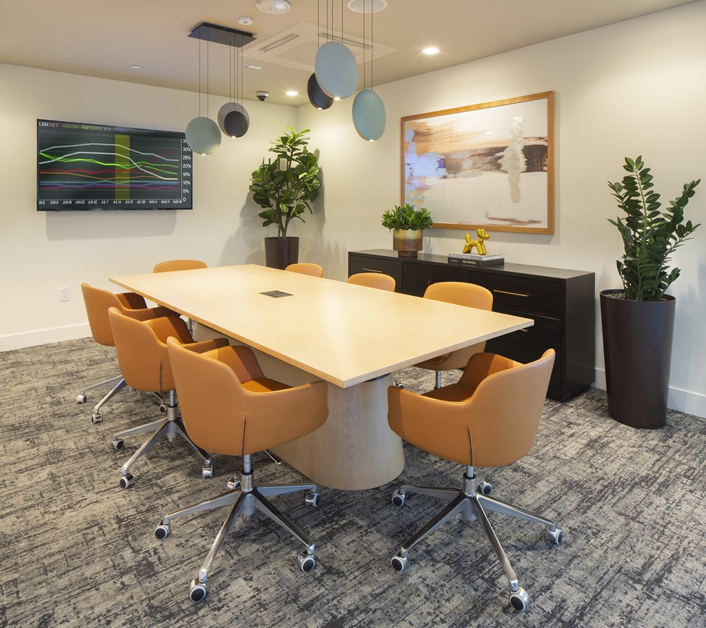 an empty conference room with a table and chairs