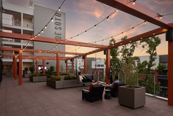 A Desoto sign is hanging from a pergola on a patio.