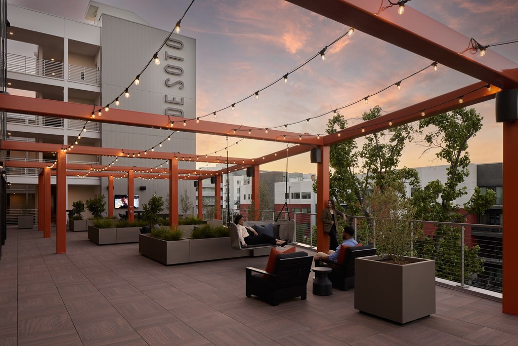 A Desoto sign is hanging from a pergola on a patio.