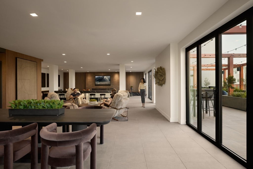 A modern dining room with a table set for four.
