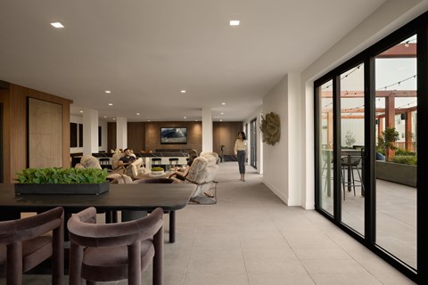 A modern dining room with a table set for four.