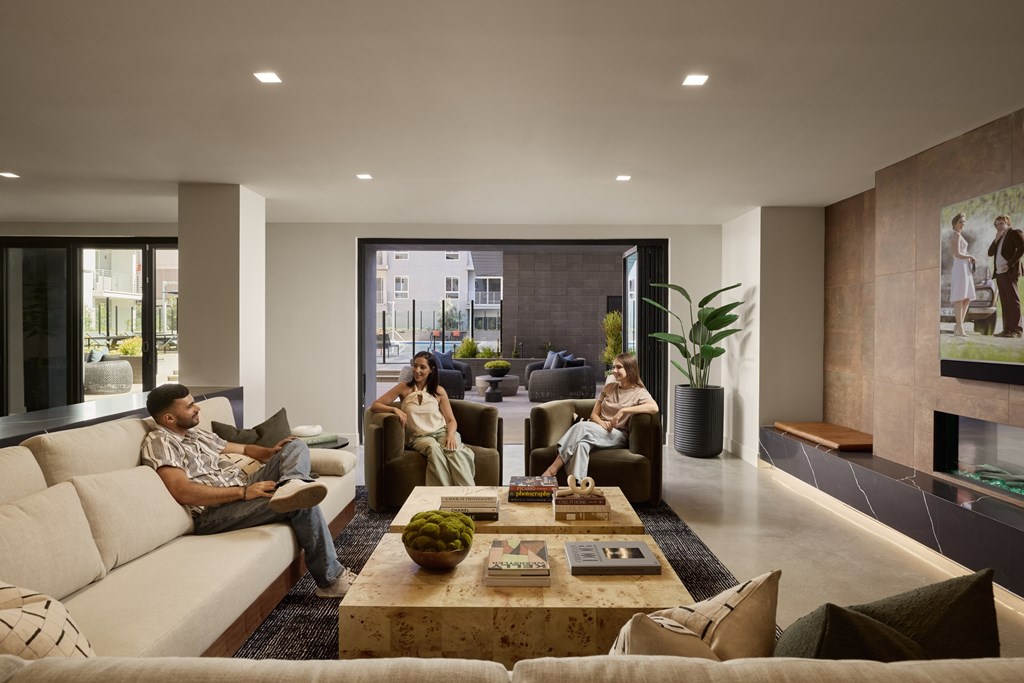 A group of people are sitting in a modern living room.
