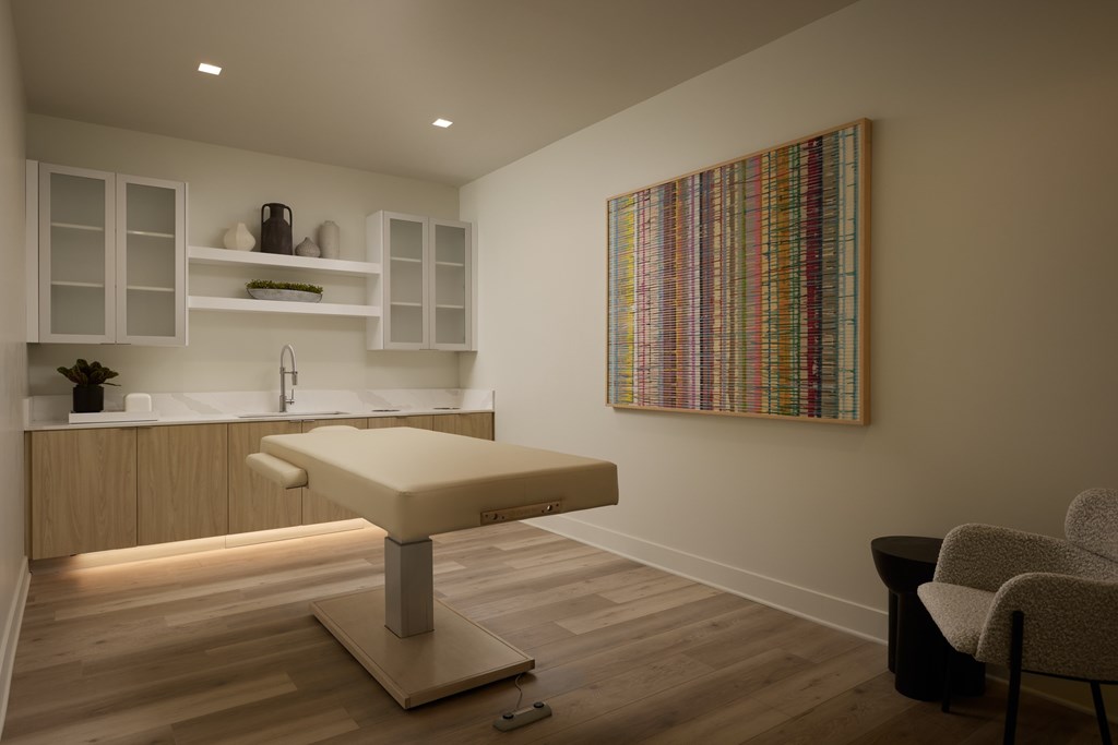 A room with a chair and a table in front of a painting.