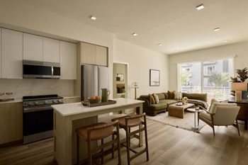 A modern kitchen with a dining area and a living room.