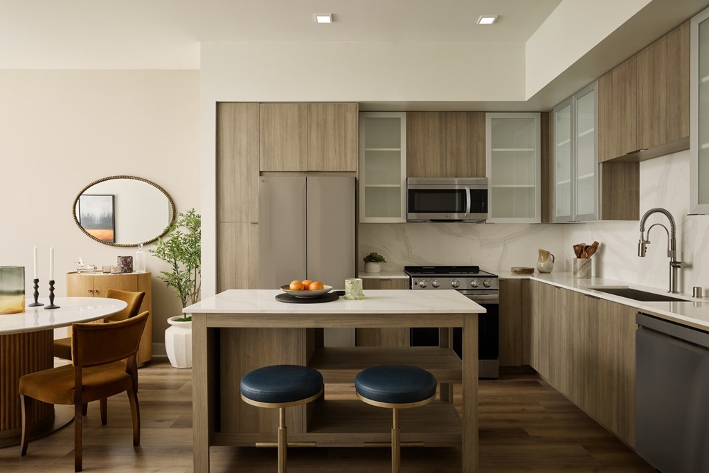 A modern kitchen with a dining table and chairs.
