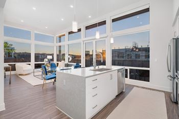a white kitchen with a large group of windows
