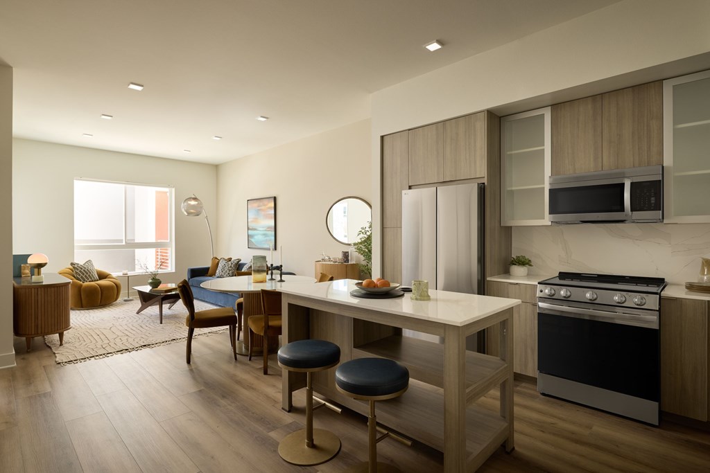 A modern kitchen with a dining table and chairs.