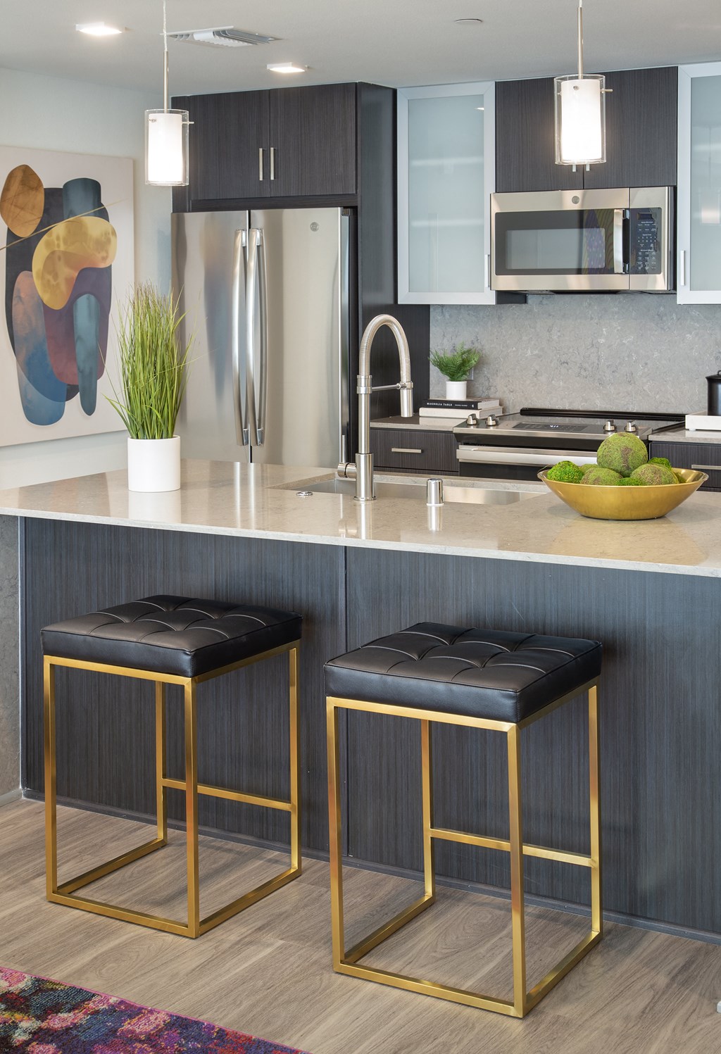 a kitchen with two stools in front of a counter