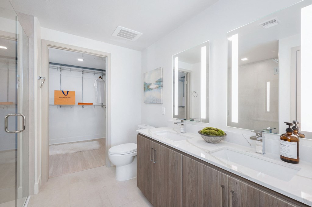 a bathroom with a sink and a toilet and a shower