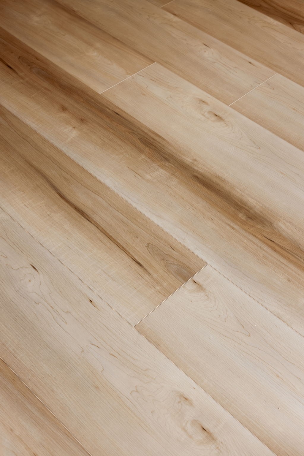 A wooden floor with light brown planks.